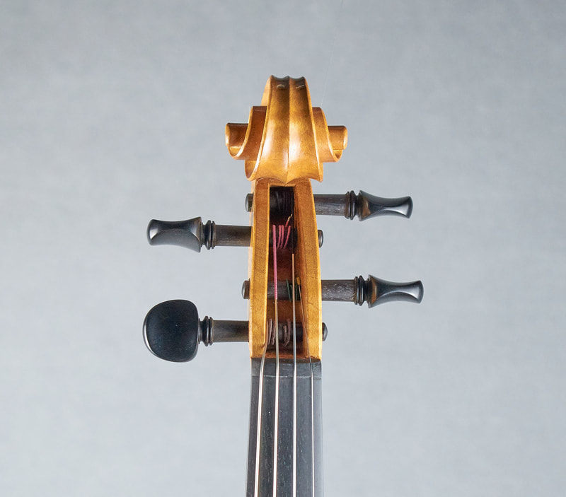 The scroll of a hand made Brazenose Etere violin (front view). 