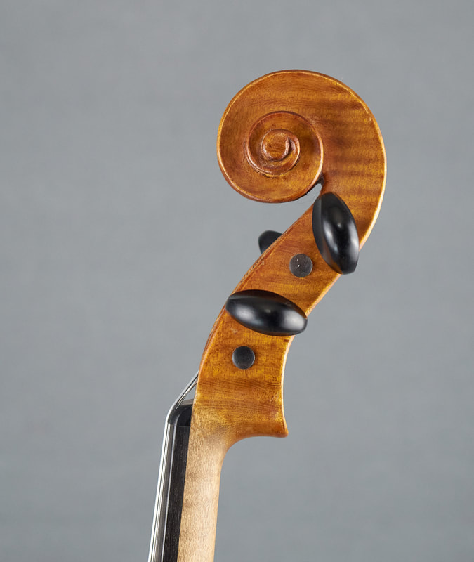 The scroll of a Theo Parmakis violin with exceptional sound and playability (side view).